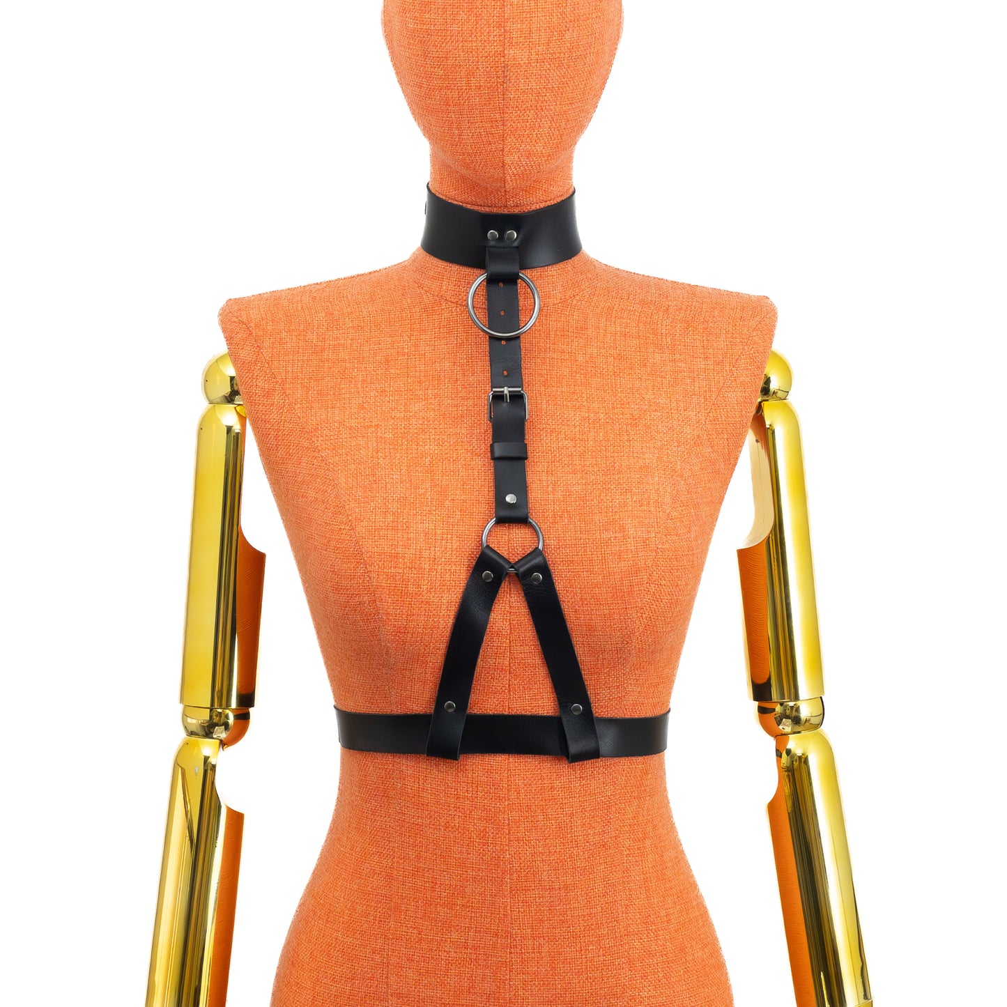 Front view on mannequin of black leather harness with wide collar, central ring at neck, adjustable vertical strap and lower ring with two straps forming loops around 1 inch waist belt; dark nickel hardware visible.