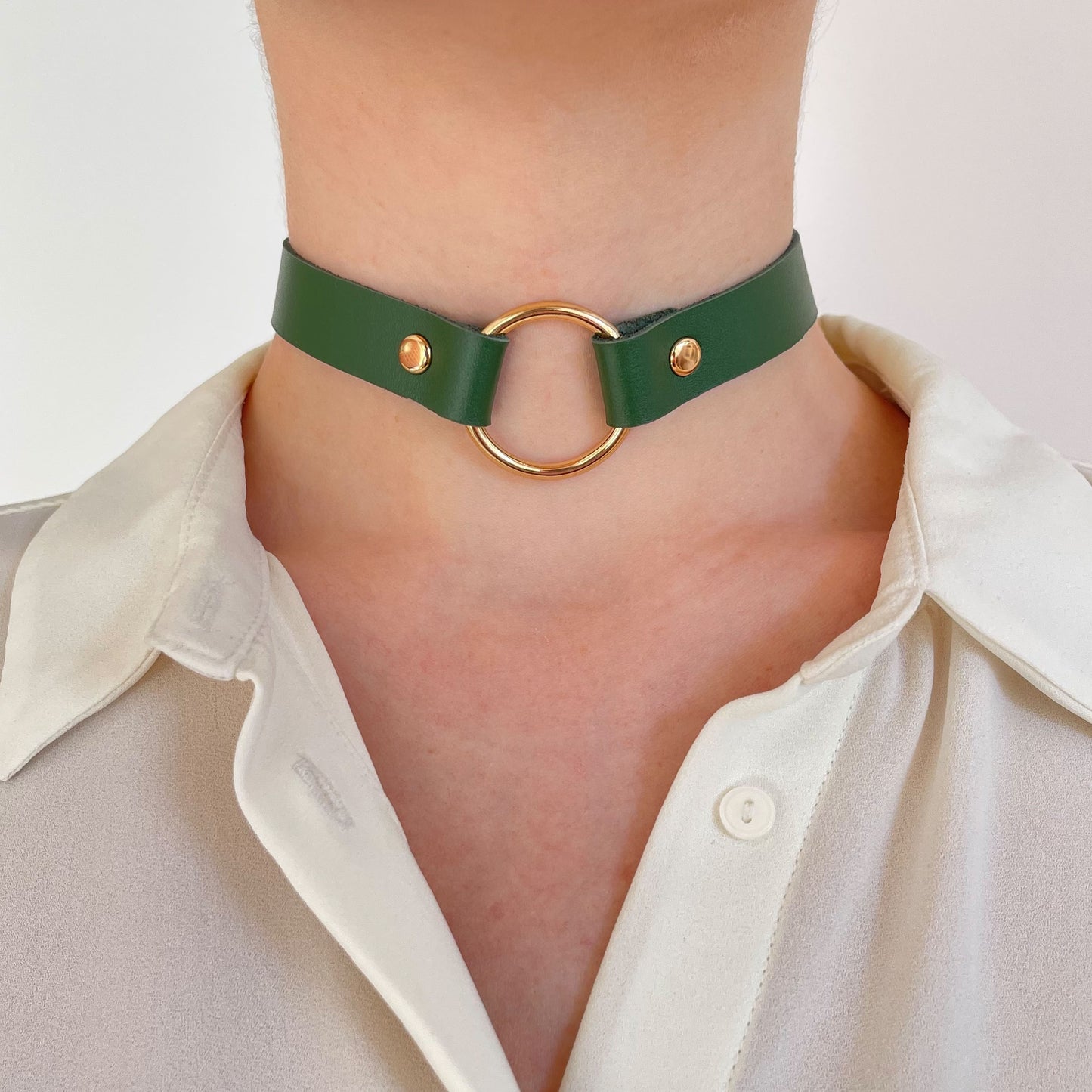 Green leather choker with gold ring – front view centered on neck with white shirt