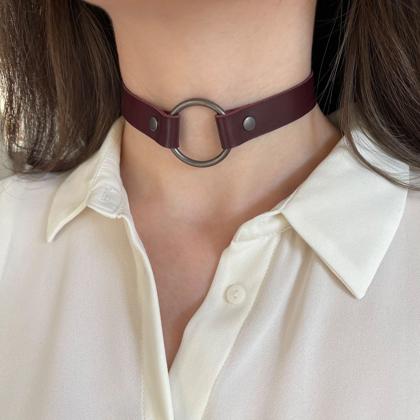 Marsala leather choker with black O-ring – angled front view on model wearing white blouse