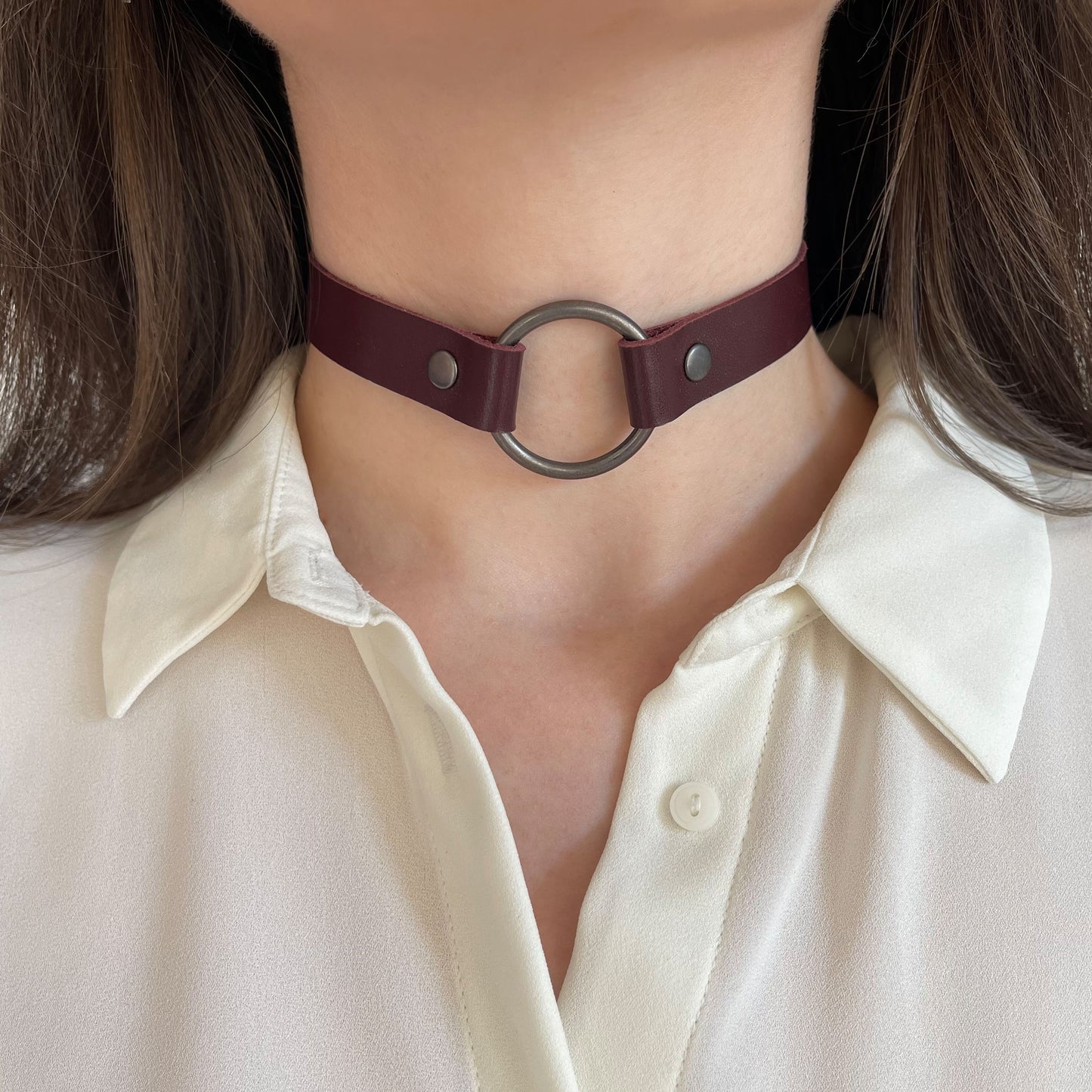 Marsala leather choker with large black O-ring – front view on model in white blouse.