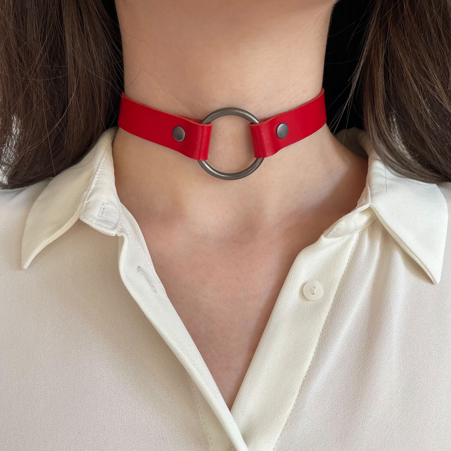 Red leather O-ring choker – centered front view on neck with white blouse.