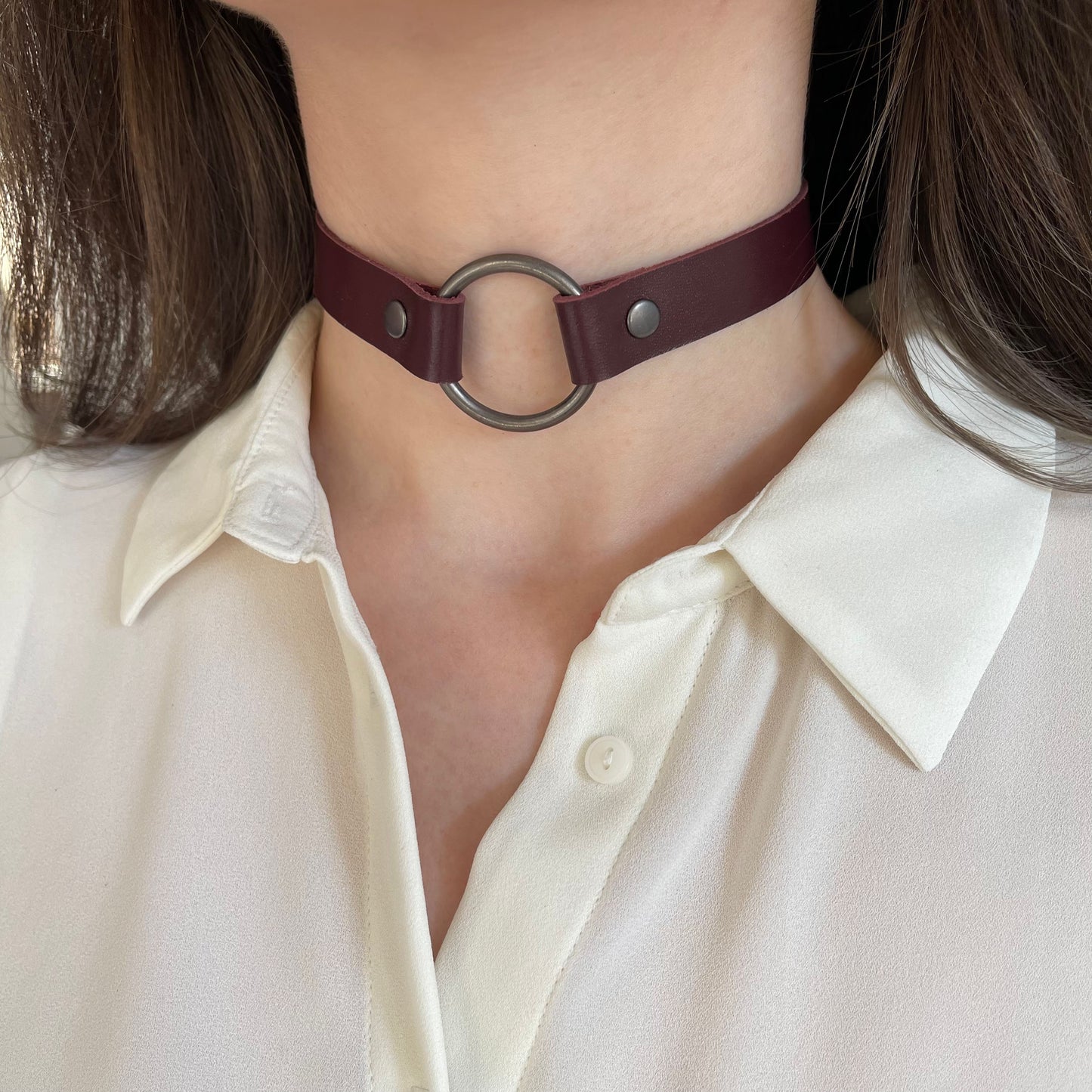 Marsala leather choker with black O-ring – angled front view on model wearing white blouse