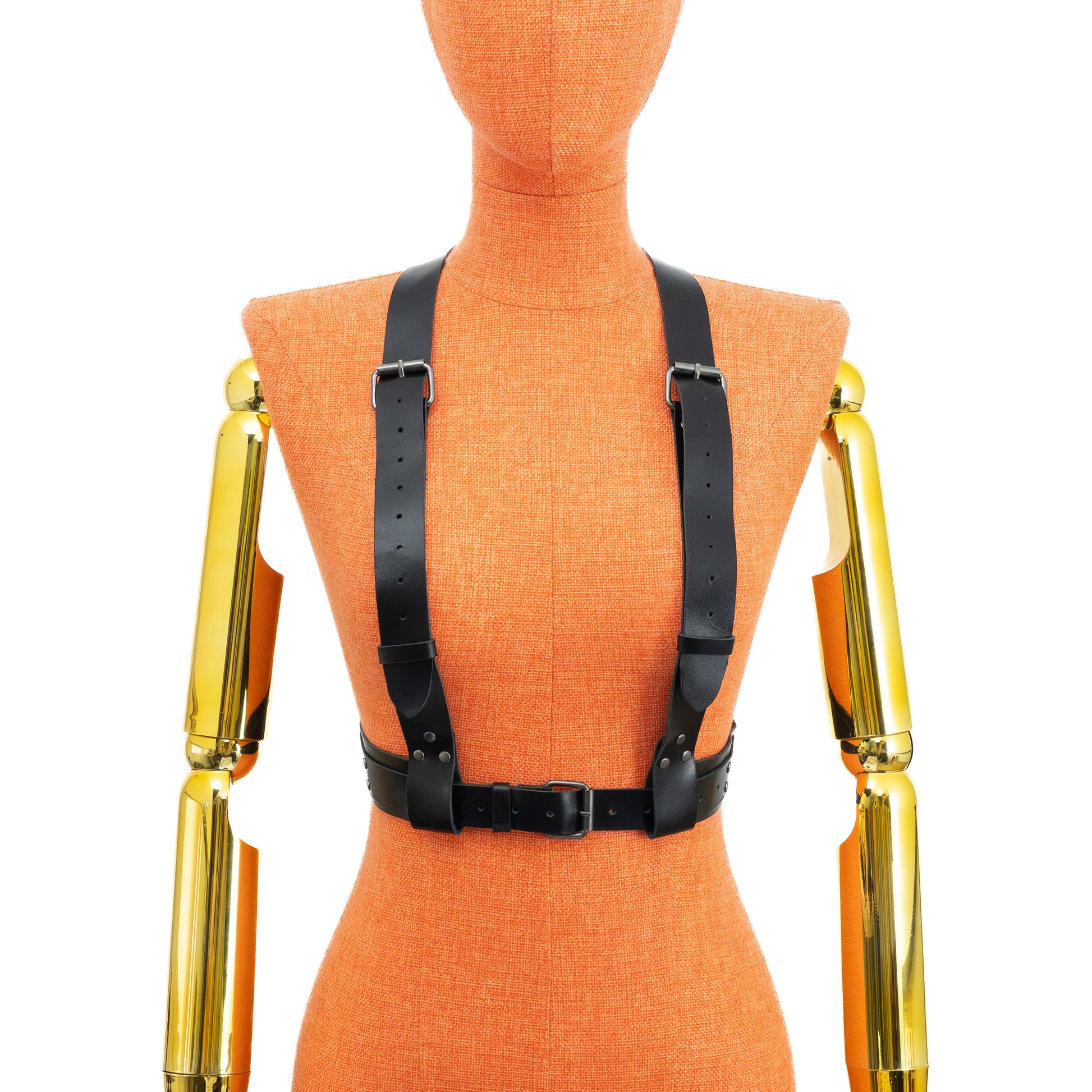 Front view of a black genuine leather reversible chest harness on a mannequin, worn with two 1 1/4 inch straps running over the bust and shoulders to the waist belt; waist belt width 1 1/2 inch with layered 1 inch strap and dark nickel hardware visible.