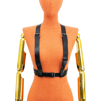 Front view of a black genuine leather reversible chest harness on a mannequin, worn with two 1 1/4 inch straps running over the bust and shoulders to the waist belt; waist belt width 1 1/2 inch with layered 1 inch strap and dark nickel hardware visible.