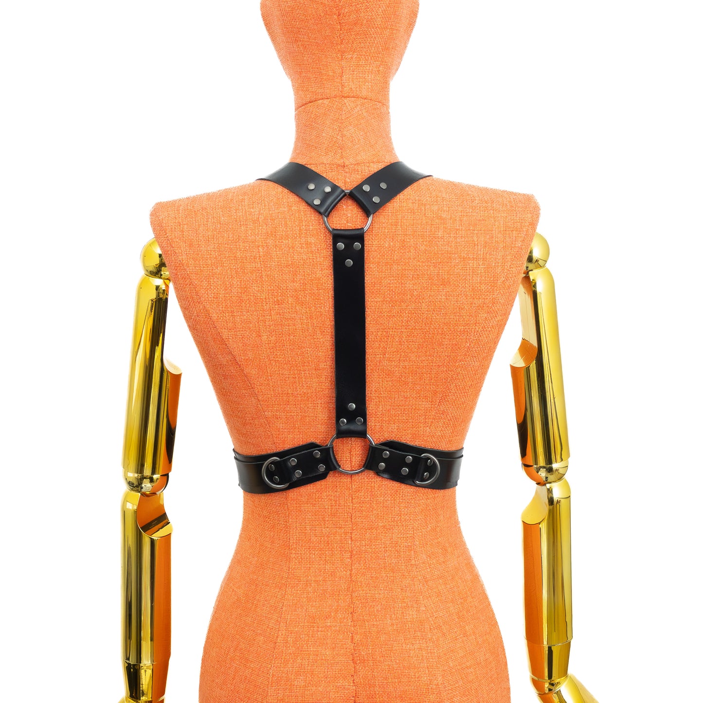 Three-quarter front view of a black leather chest harness on a mannequin, showing double front straps over the bust, adjustable buckles on shoulder straps, and wide waist belt with layered 1 inch strap secured under the bust; dark nickel hardware.