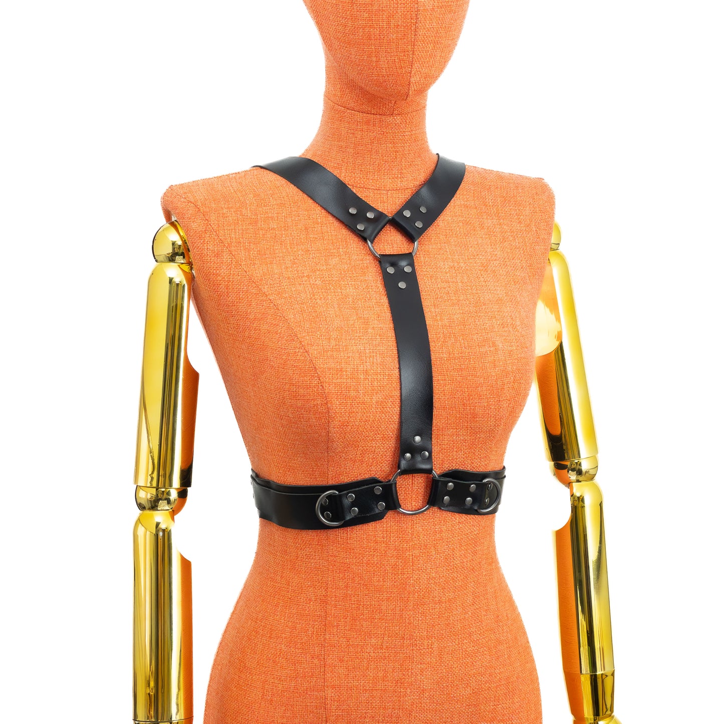 Back view of a black leather reversible chest harness on a mannequin, showing two shoulder straps merging into a single vertical strap attached to a ring between the shoulder blades, continuing down to a central ring on the 1 1/2 inch waist belt; dark nickel hardware.