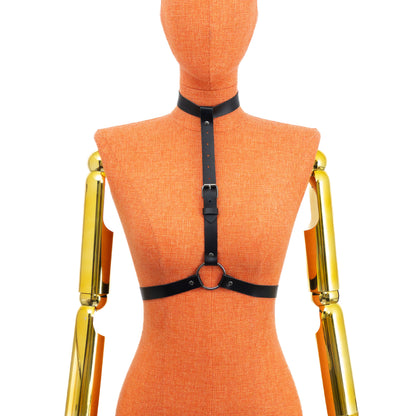 Black genuine leather minimalist O-ring harness on mannequin, dark nickel hardware, front view showing 3/4 inch (2 cm) choker, vertical strap and waist belt connected through central O-ring; leather thickness 1.4–1.8 mm.