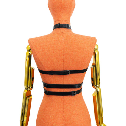Black genuine leather triple strap chest harness on mannequin with dark nickel hardware, back view showing three horizontal back straps with adjustable buckles and choker buckle closure; leather thickness 3.5–4.5 oz (1.4–1.8 mm).