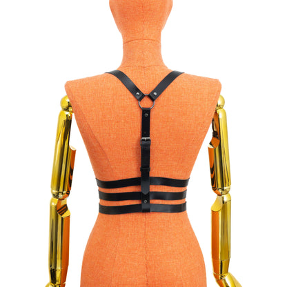 Triple Waist Strap Leather Harness on mannequin, back view, genuine black leather with dark nickel hardware, vertical spine strap with buckle, ring between shoulder blades and three horizontal waist straps with adjustable buckles; leather thickness 3–4 oz (1.4–1.8 mm).