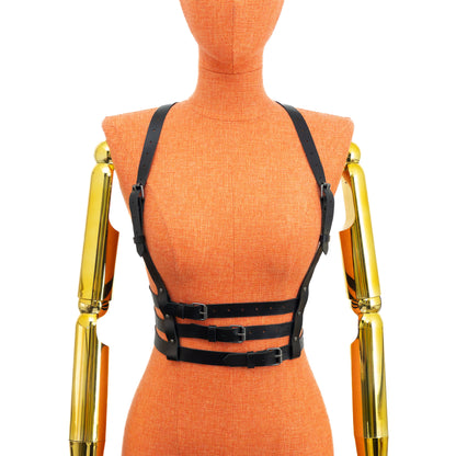 Triple Waist Strap Leather Harness on mannequin, front view, genuine black leather with dark nickel hardware, three horizontal waist straps and shoulder lines connected through central back ring structure; leather thickness 3–4 oz (1.4–1.8 mm).