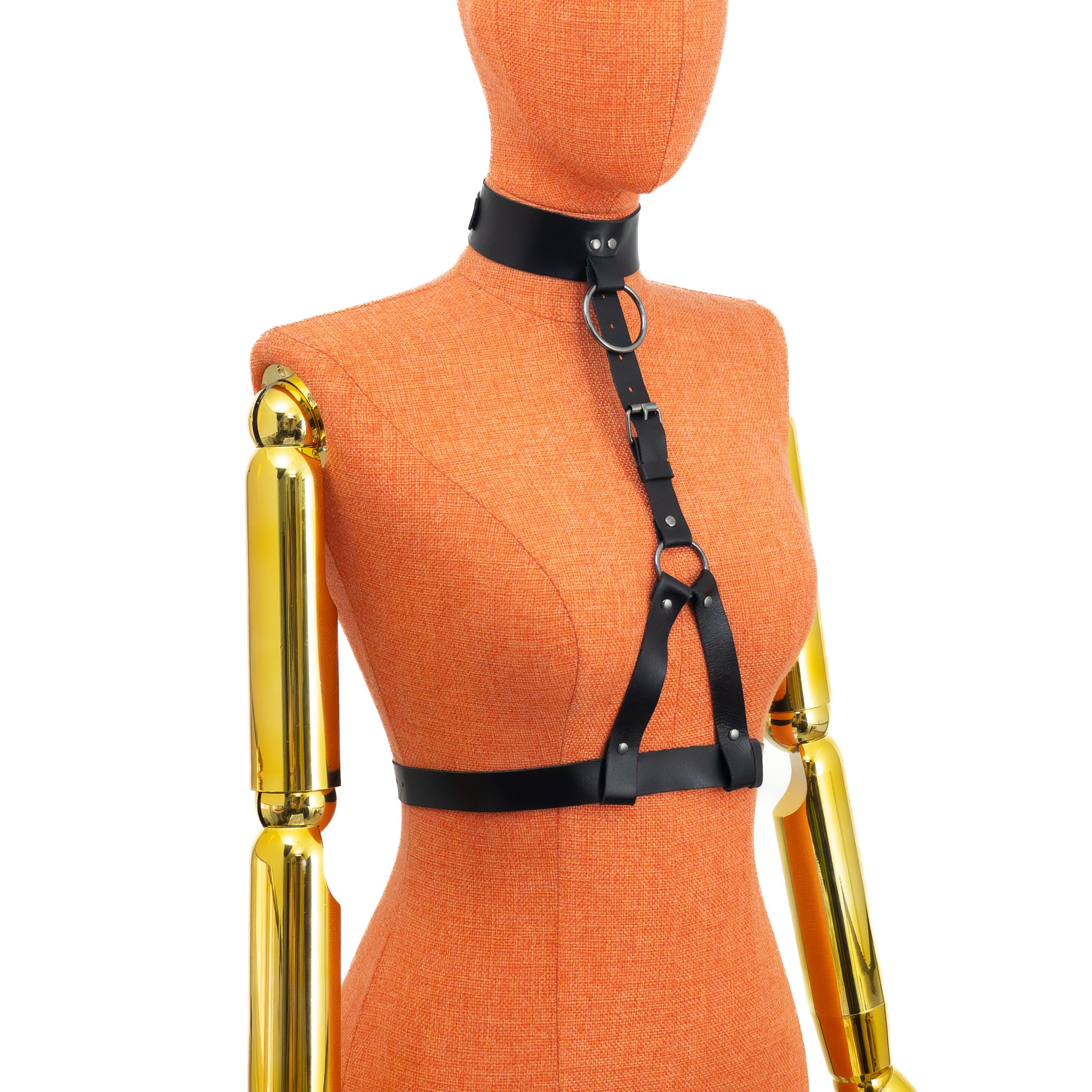 Three-quarter back view on mannequin of black leather harness with wide collar, showing back buckle of collar and waist belt and how vertical strap structure aligns at the front; dark nickel hardware visible.