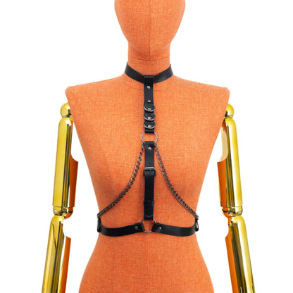 Back view on mannequin of black leather collar harness, showing buckle fastening at the neck and at the waist, with dark nickel hardware; the construction is secured from the back for fit adjustment.