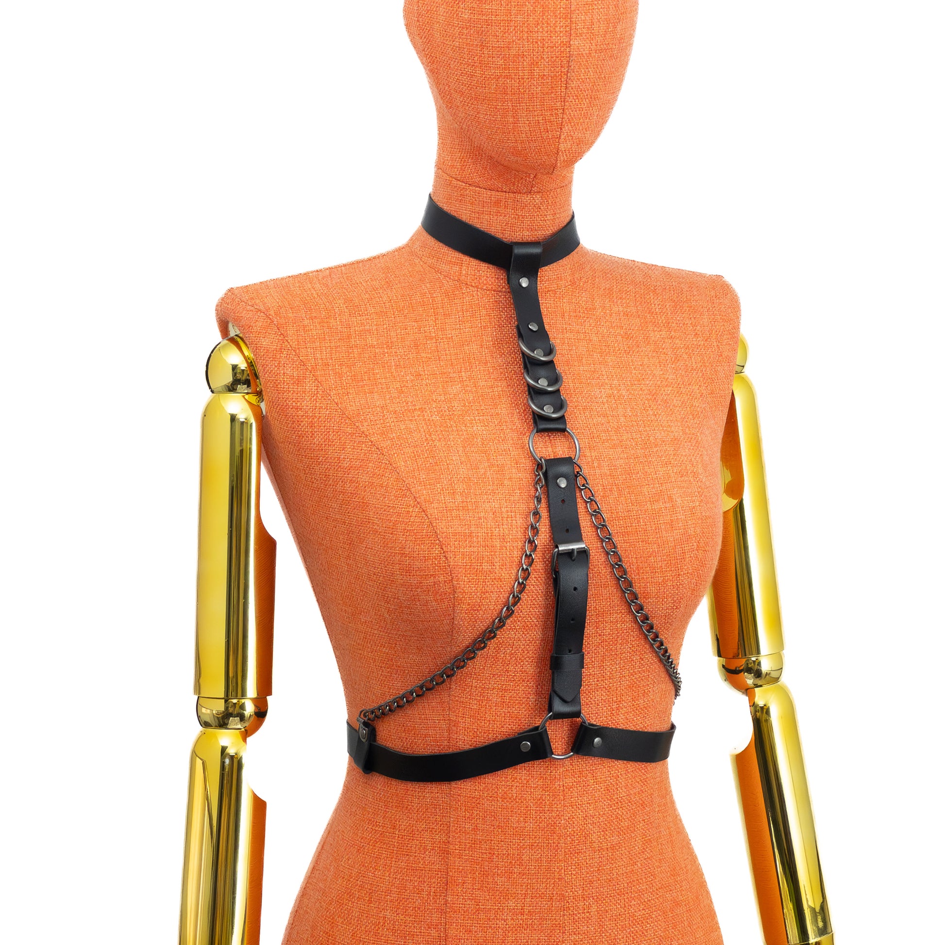 Three-quarter view on mannequin of black genuine leather collar harness, showing the vertical strap system with round rings, central round ring between the bust area, double chains, and dark nickel hardware with D-rings placed on the straps.