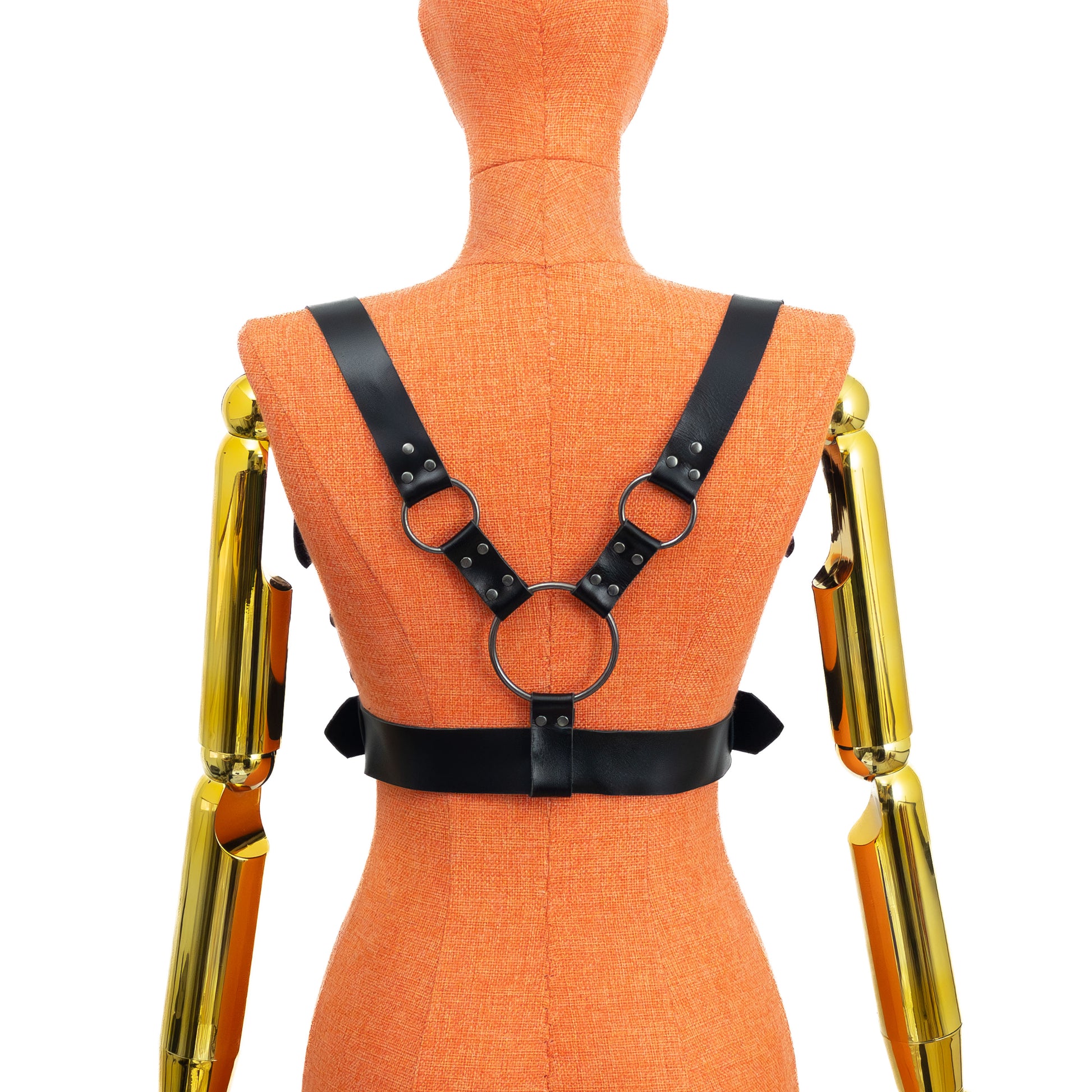 Back view of a black leather wide waist chest harness on a mannequin, showing the large central ring and two smaller rings forming the back structure, with the wide waist belt wrapping around the torso; dark nickel hardware visible; leather thickness 1.4–1.8 mm.