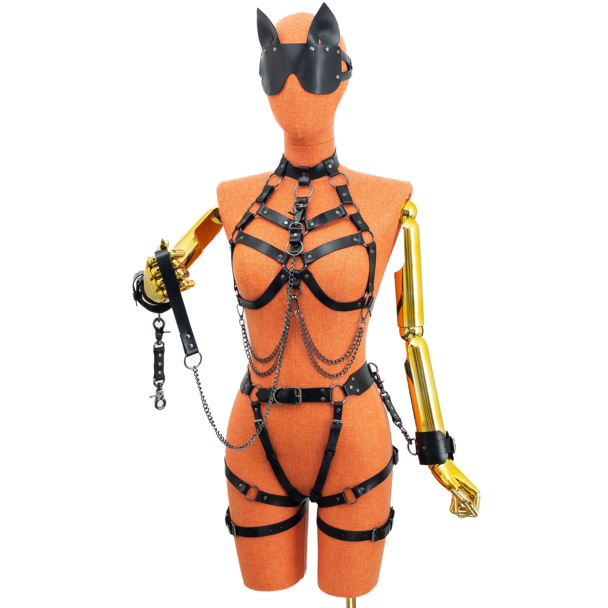 Full view of the set worn with a wide cat-ear blindfold, with one hand holding the leather leash, which is clipped to a D-ring to the neck of the harness.