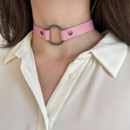 Pink leather choker with black ring – angled view on neck with white shirt