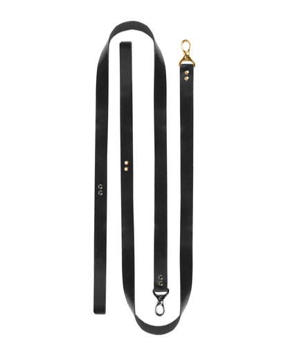 BDSM full leather leash on a white background made from a single solid black leather strap, 100 cm (39.37 in) length, 2 cm (0.79 in) width, 1.4–1.8 mm (0.06–0.07 in) thickness, laid flat with clean leather edges visible.