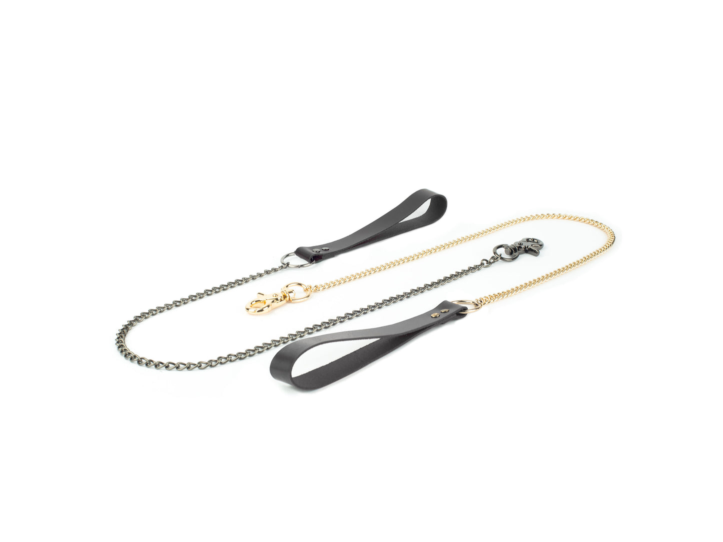 Close-up of two leather leashes, one with a gold chain and one with a dark nickel chain, showing the leather handles and the metal clasps.
