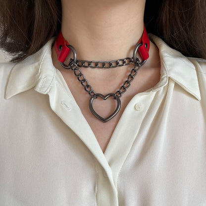 Red genuine leather choker with dark metal chain and heart ring, close-up front view