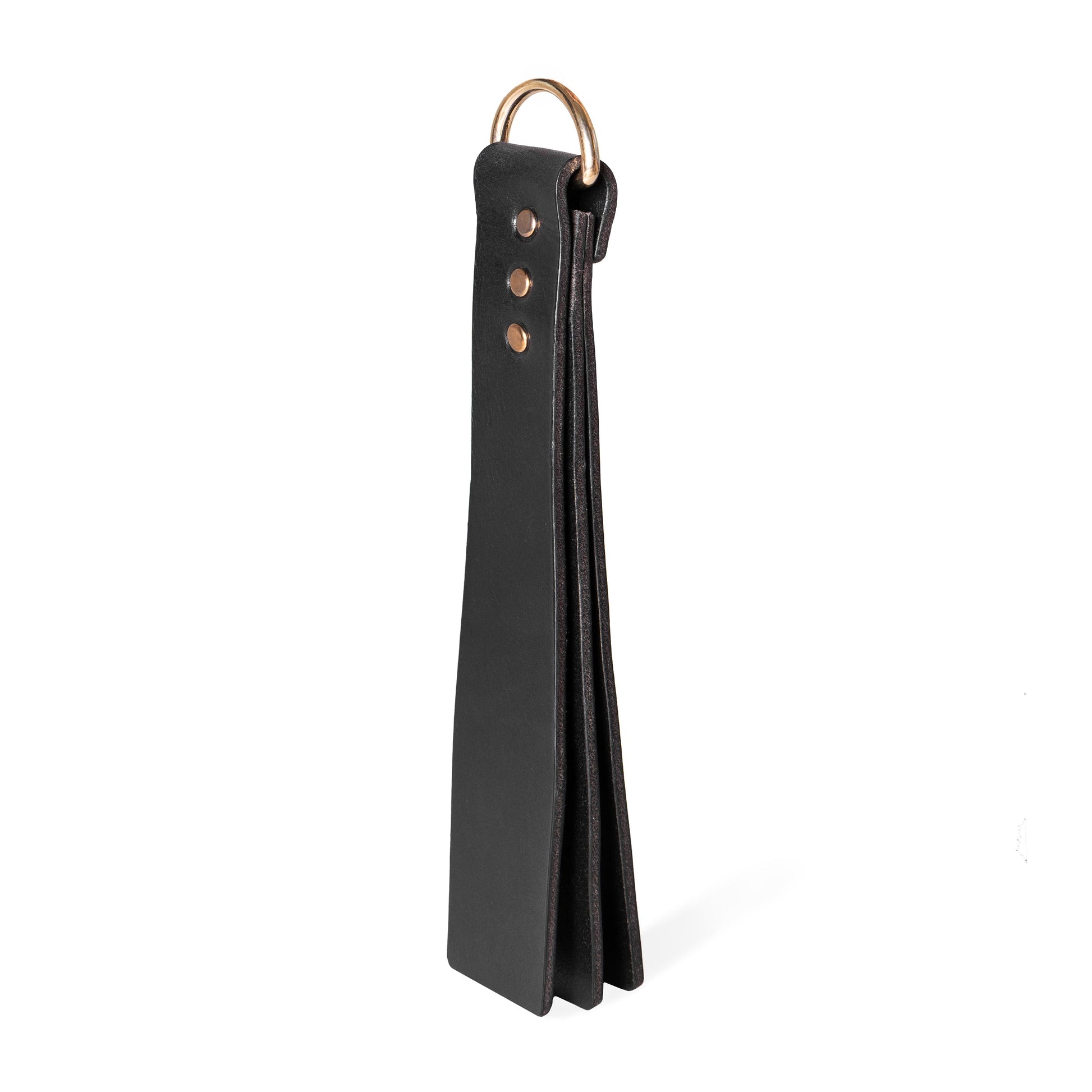 Handmade Basic Wide leather BDSM paddle photographed upright on a white background. The image shows a three-layer leather construction with a wide striking surface and a metal D-ring attached to the handle.