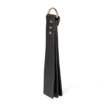 Handmade Basic Wide leather BDSM paddle photographed upright on a white background. The image shows a three-layer leather construction with a wide striking surface and a metal D-ring attached to the handle.