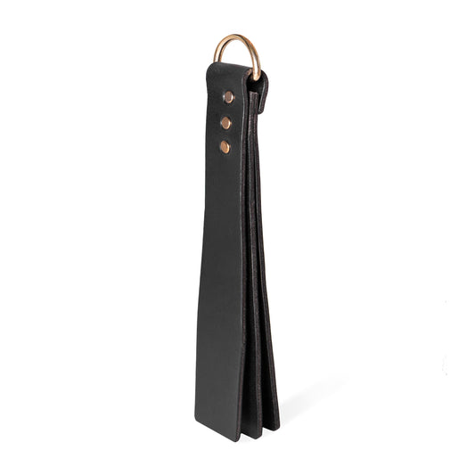 Handmade Basic Wide leather BDSM paddle photographed upright on a white background. The image shows a three-layer leather construction with a wide striking surface and a metal D-ring attached to the handle.