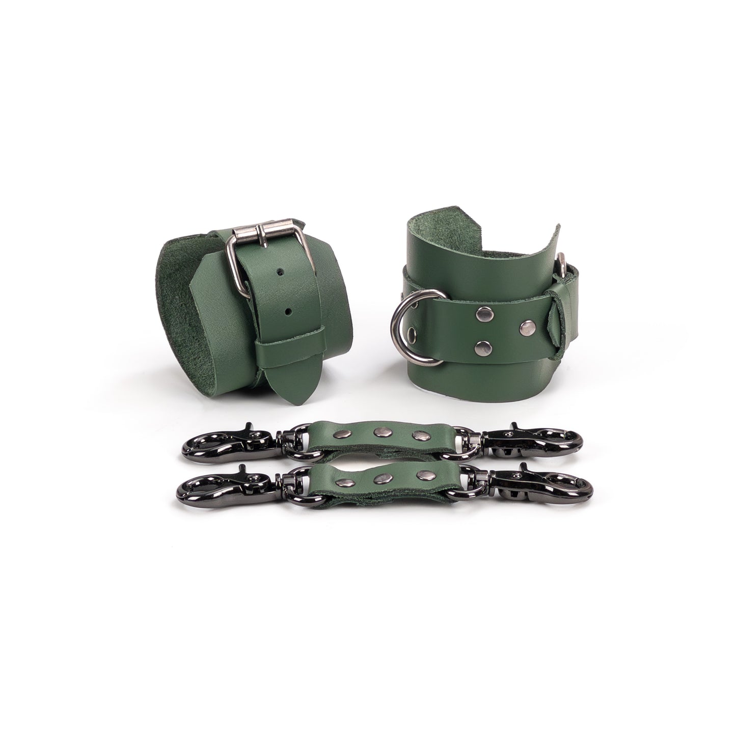 Two green genuine leather ankle cuffs with dark nickel hardware displayed flat, one shown from the buckle fastening side and the other angled to show the metal D-ring. Each cuff has a 6 cm (2.36 in) wide base and a 2.5 cm (0.98 in) strap, with two green leather connectors placed in front.