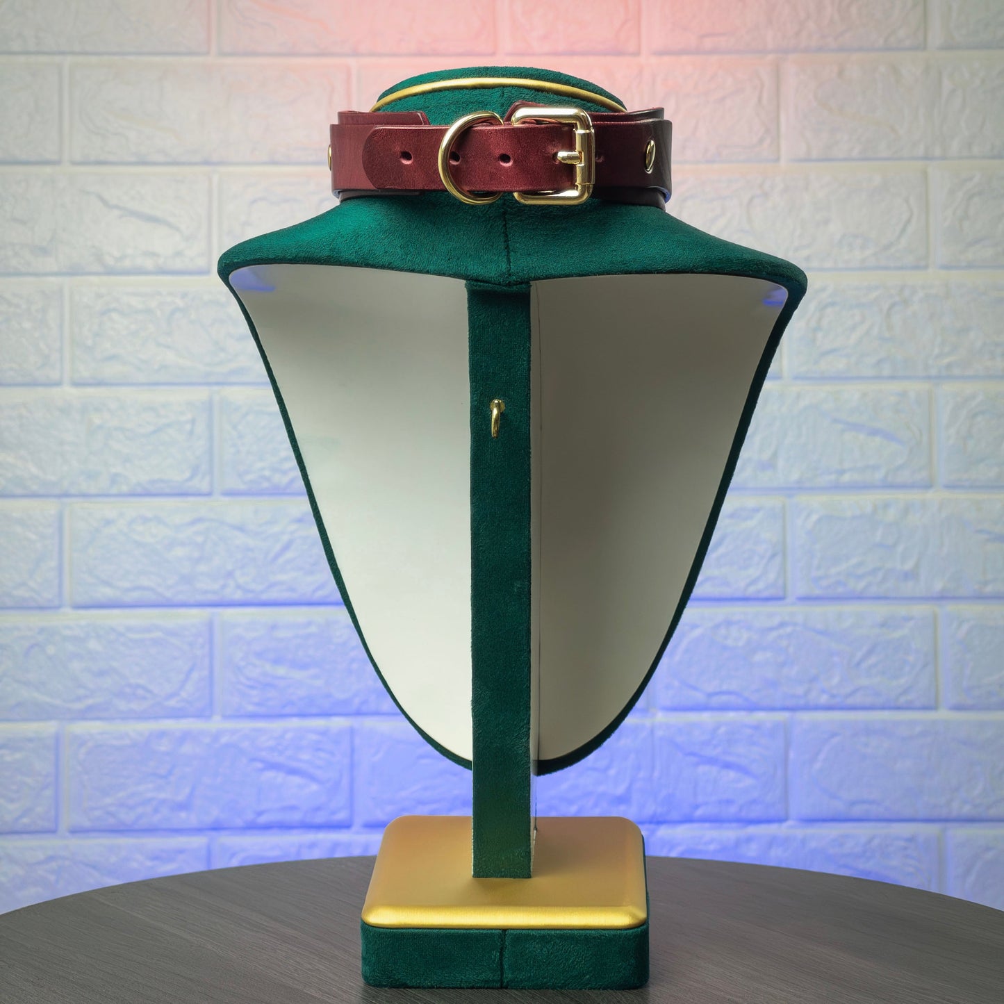 Back view marsala choker on a stand against a textured white wall.