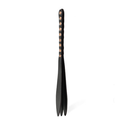 Handmade Submissive Tear leather BDSM paddle photographed upright on a white background. The image shows a three-layer leather construction with a slim handle, teardrop-shaped striking surface, and smooth rounded profile designed for controlled impact play.
