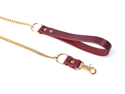 Marsala leather leash with gold chain and clasp on a white background