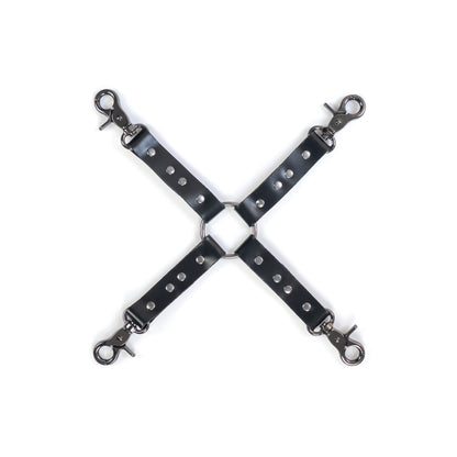 Four-way leather restraint connector made of black genuine leather with dark nickel metal hardware, central metal ring with four attachment ends, each end has a dark nickel carabiner, shown flat on a white background, top view with stitching and rivets visible.
