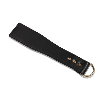 Handmade Basic Wide leather paddle displayed flat on a white background. The photo highlights the wide three-layer striking surface, clean straight profile, smooth edges, and the metal D-ring integrated into the handle.