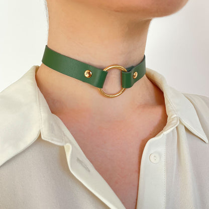 Green leather choker with gold O-ring – angled front view on white blouse