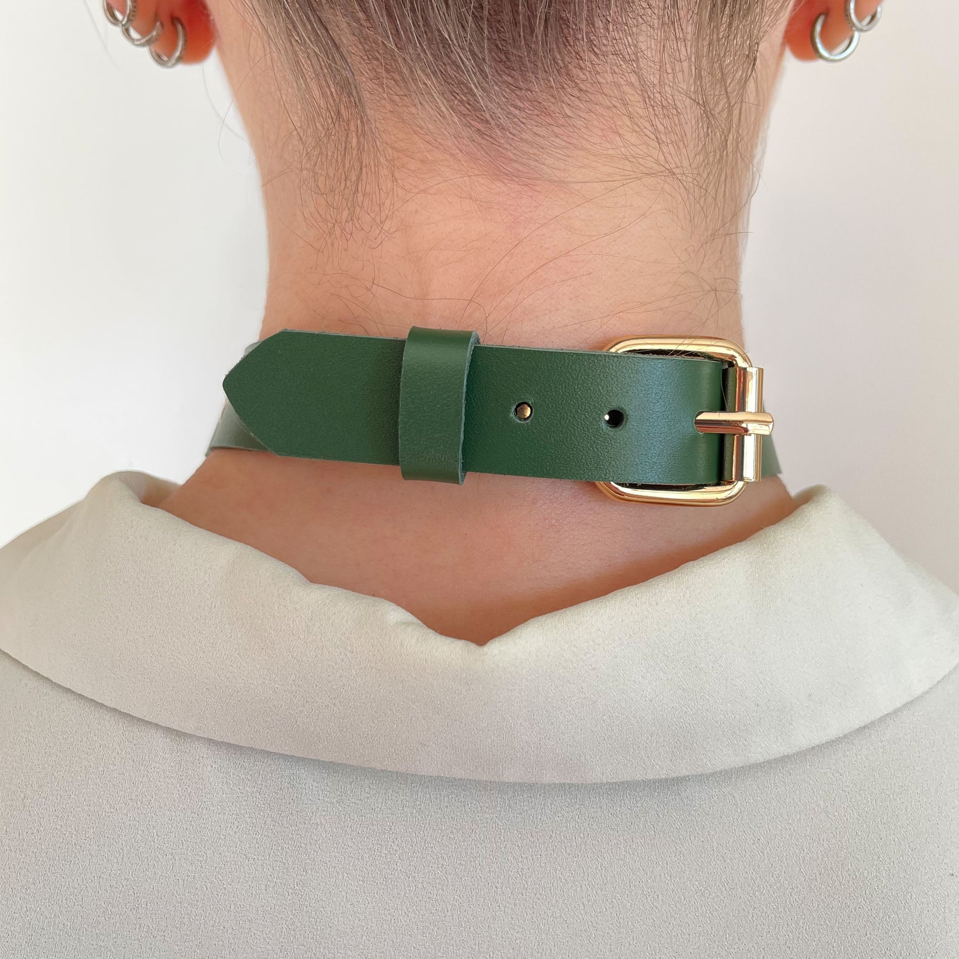 Back view of green leather choker with gold adjustable buckle and clean leather finish.