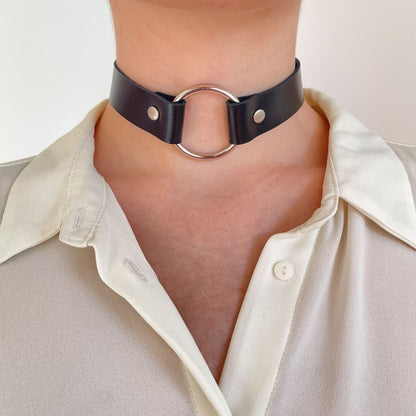 Full front view of black choker with silver O-ring and rivets, centered on neck