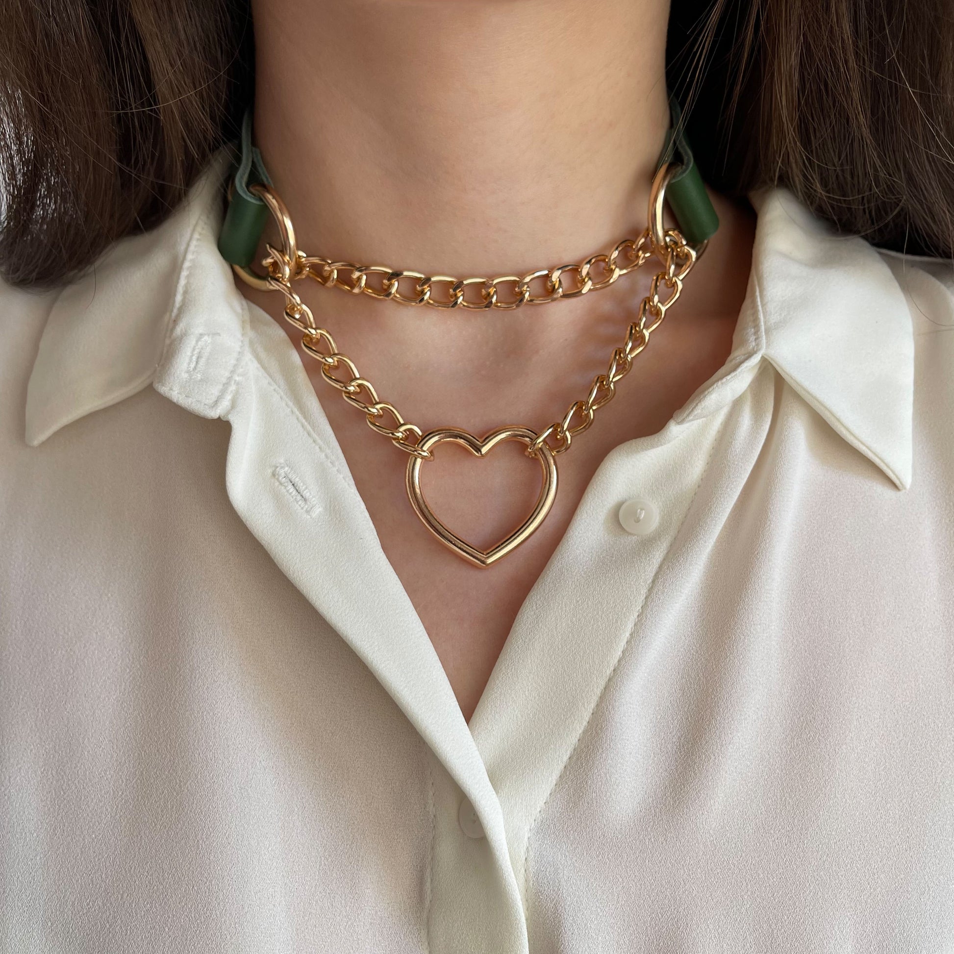 Green genuine leather choker with double gold chain and heart pendant, front view