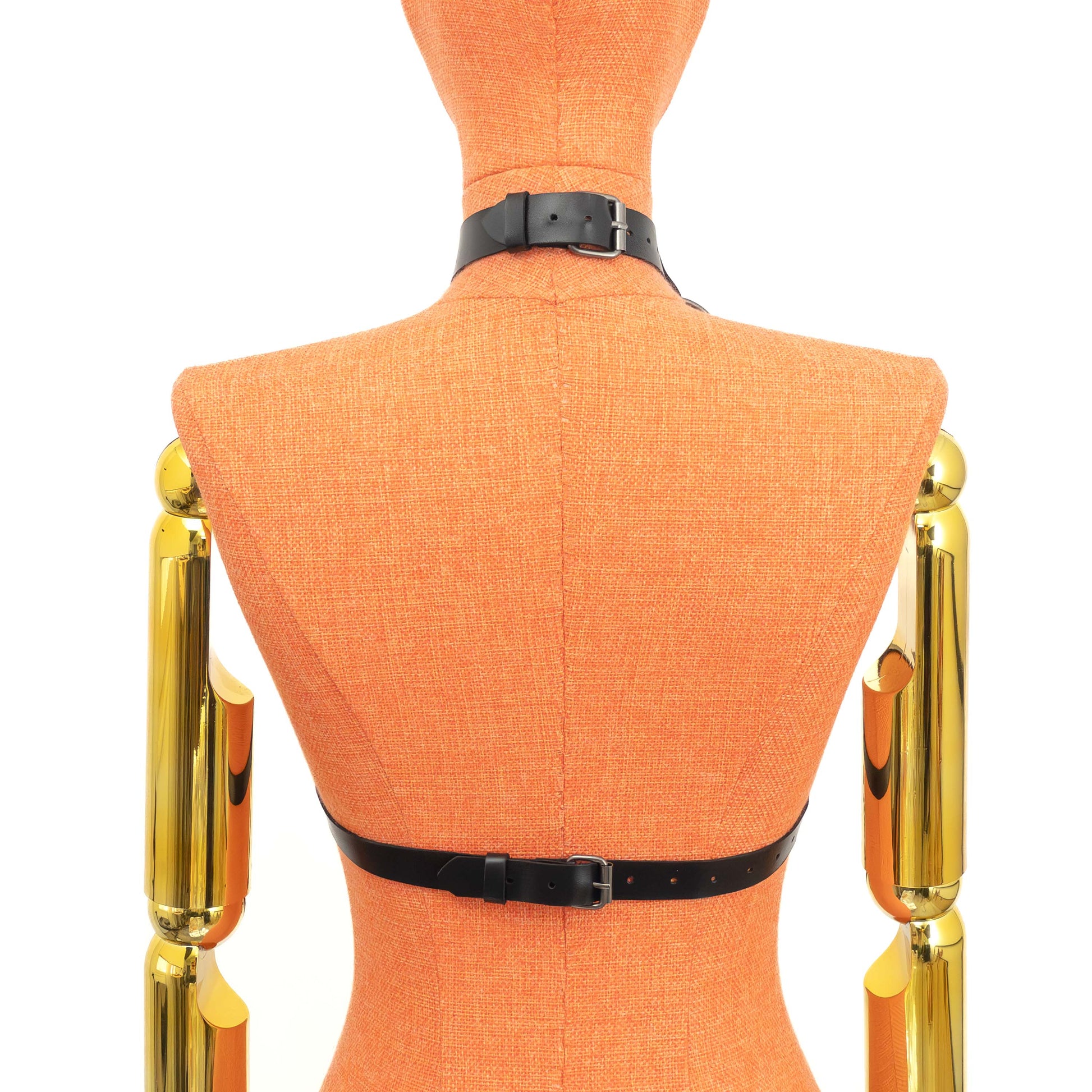 Open Bust Cage Leather Harness with Removable Chains on mannequin, back view, genuine black leather with dark nickel hardware, choker buckle closure at neck and separate buckle fastening at back band, vertical straps visible from collar; strap width 3/4 inch (2 cm), leather thickness 3–4 oz (1.4–1.8 mm).
