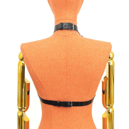 Open Bust Cage Leather Harness with Removable Chains on mannequin, back view, genuine black leather with dark nickel hardware, choker buckle closure at neck and separate buckle fastening at back band, vertical straps visible from collar; strap width 3/4 inch (2 cm), leather thickness 3–4 oz (1.4–1.8 mm).