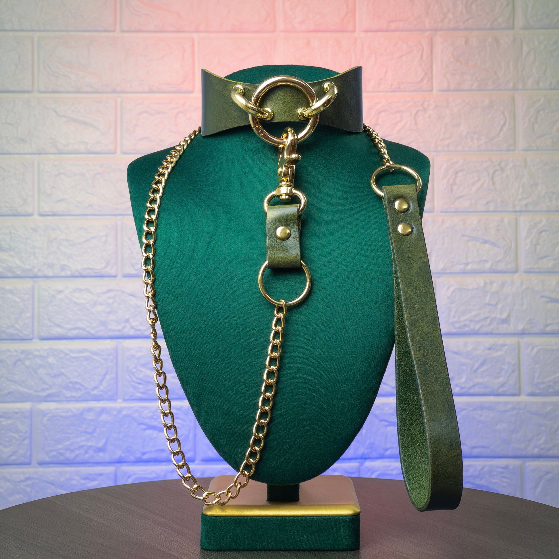 Bondage collar and leash a green mannequin against a textured white background
