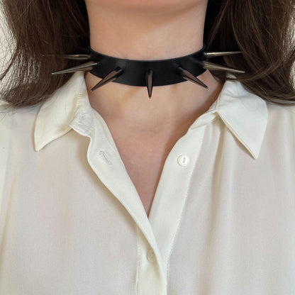 Leather spiked collar worn on the neck, front view, with long cone spikes in dark nickel color