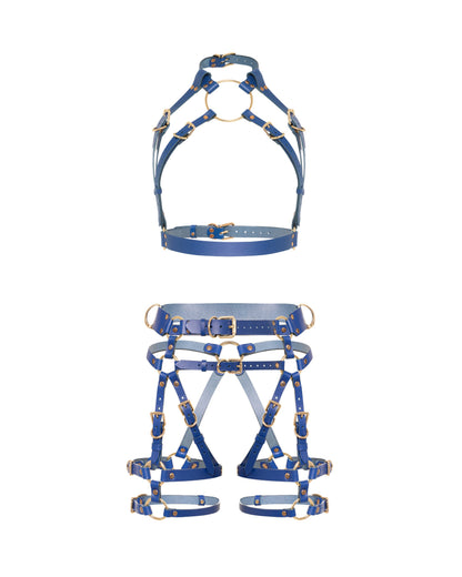 Front view of a deep blue leather full body  harness set with an open bust harness, open crotch garter belt, removable leather handle, large front ring, adjustable straps, and gold-tone metal hardware.