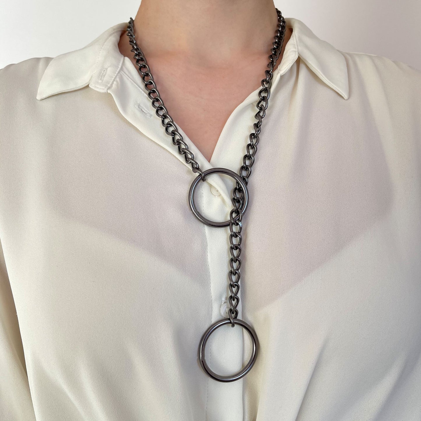Dark nickel sliding chain choking collar worn on the neck. The darker metal finish creates a heavier, muted appearance. The chain runs through a 30 mm (1.18 in) ring near the neck, with the second ring hanging lower, clearly illustrating the choking loop structure.