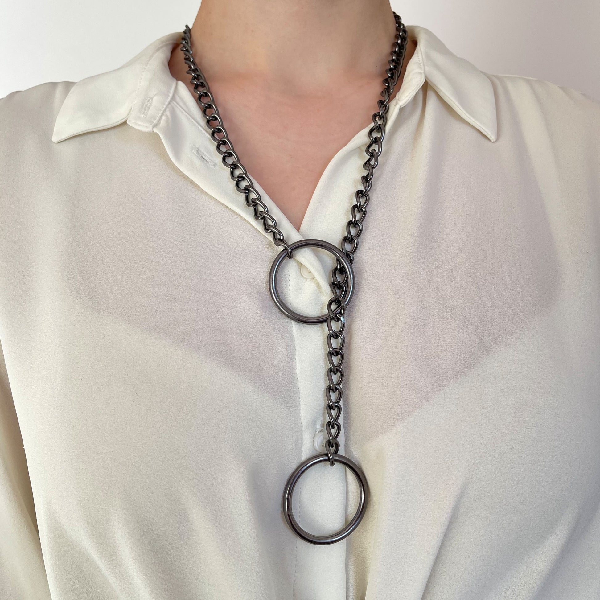 Dark nickel sliding chain choking collar worn on the neck. The darker metal finish creates a heavier, muted appearance. The chain runs through a 30 mm (1.18 in) ring near the neck, with the second ring hanging lower, clearly illustrating the choking loop structure.
