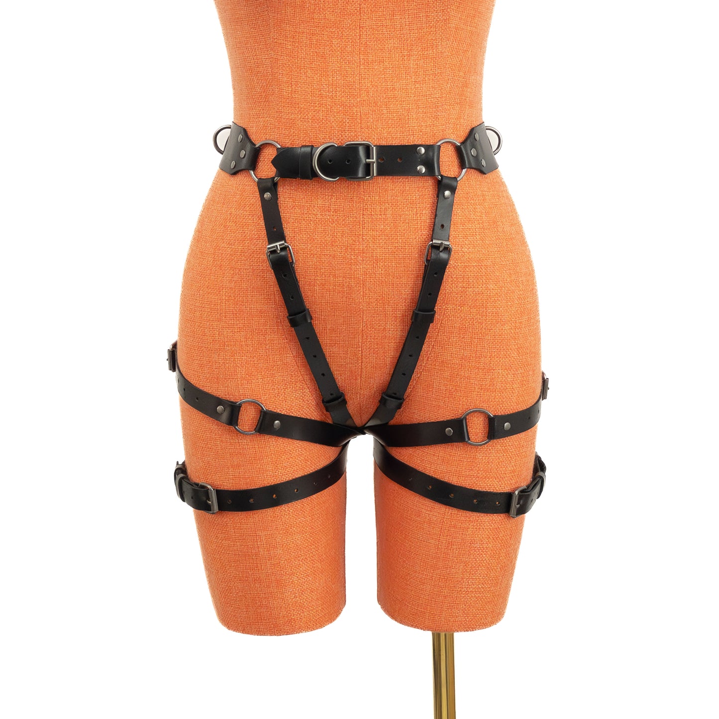 Black genuine leather open butt garter belt with dark nickel hardware displayed on mannequin, front view showing wide waist belt, side rings and vertical adjustable straps.