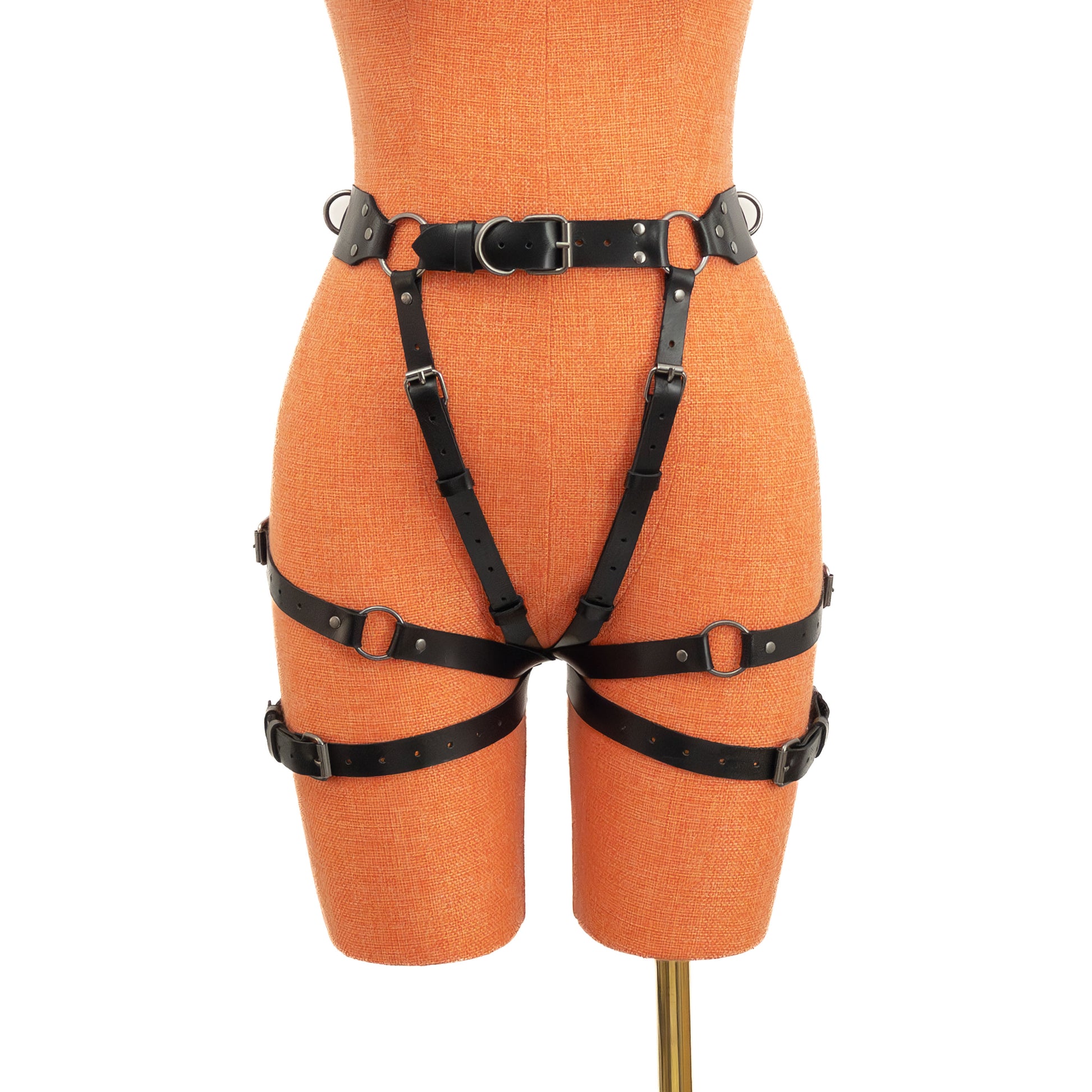 Black genuine leather open butt garter belt with dark nickel hardware displayed on mannequin, front view showing wide waist belt, side rings and vertical adjustable straps.