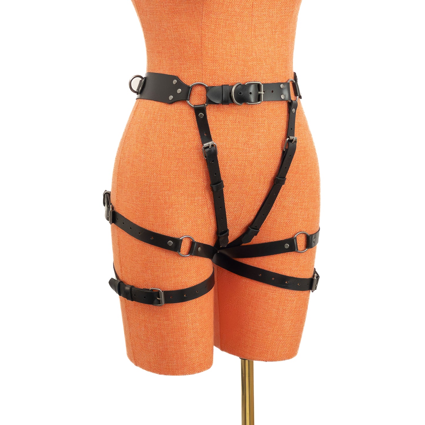 Black genuine leather open butt garter belt with dark nickel hardware on mannequin, angled front view showing thigh straps and buckle adjustments.