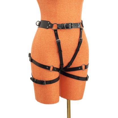 Black genuine leather open butt garter belt with dark nickel hardware on mannequin, angled front view showing thigh straps and buckle adjustments.
