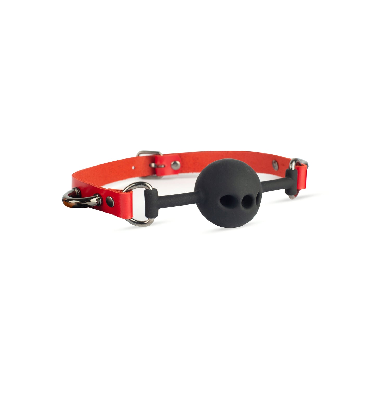 Leather ball gag in genuine red leather with dark nickel metal hardware and black silicone ball. Angled side view on white background shows riveted strap attachment to D-rings and side attachment arcs positioned near them, strap width 5/8 inch (1.5 cm), leather thickness 3–4 oz (1.4–1.8 mm).