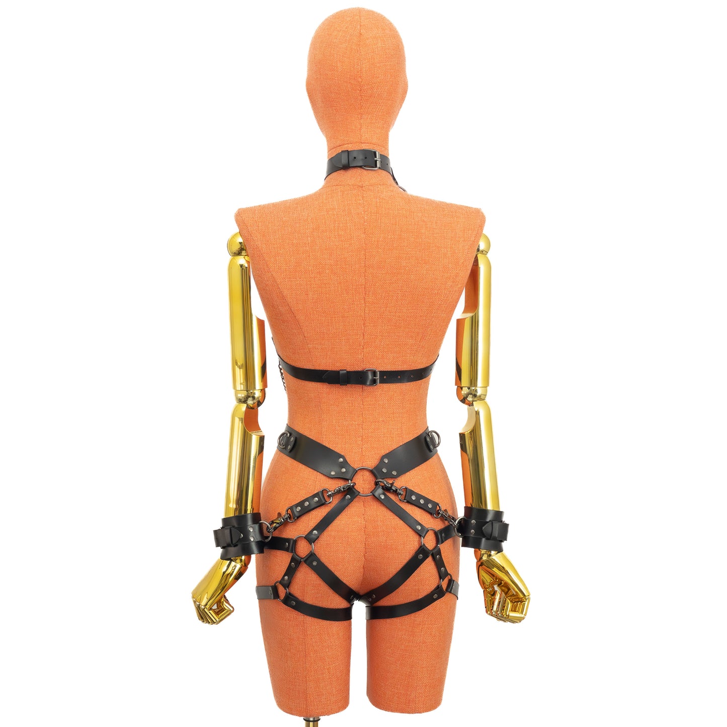 Back view of the set showing the back closure of the chest harness, the waist belt, and the garter straps wrapping around the hips, with the wrist cuffs attached to the central O-ring at the back of the waist.