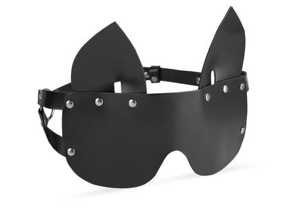 Close-up of a wide black leather blindfold with cat ears, showing the shape that covers the eyes and the ear details on top.